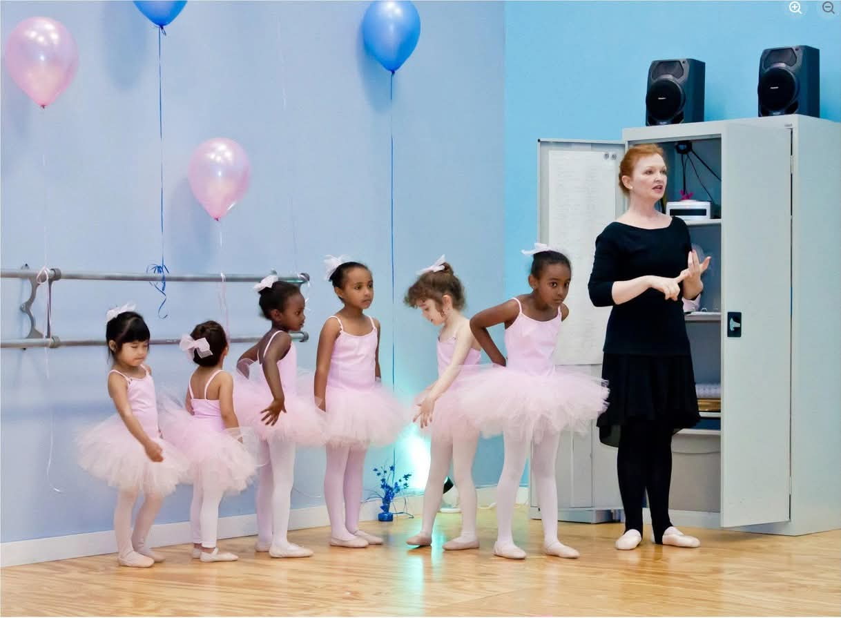 Virginia Britton teaching young ballet students in pink tutus